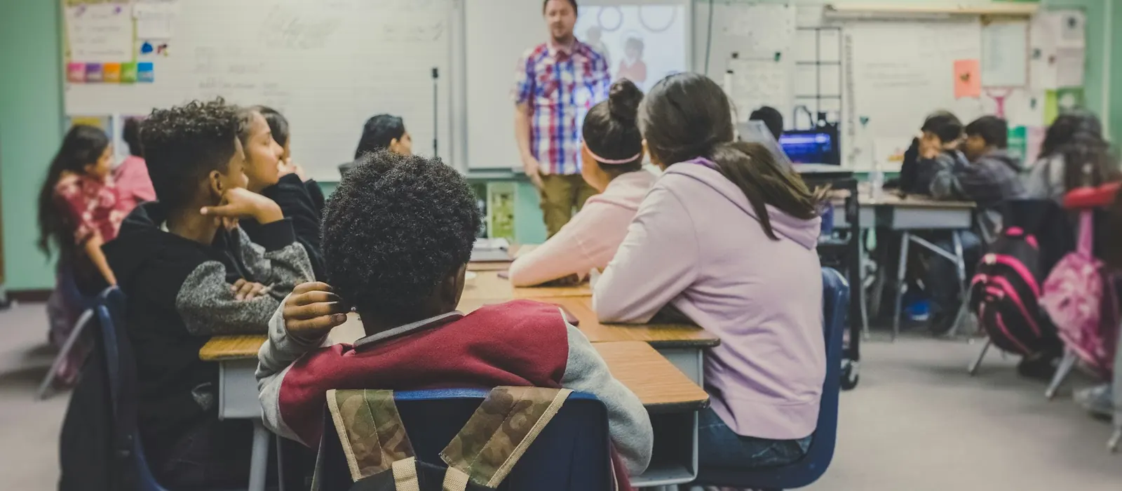 A teacher presenting to students in a classroom