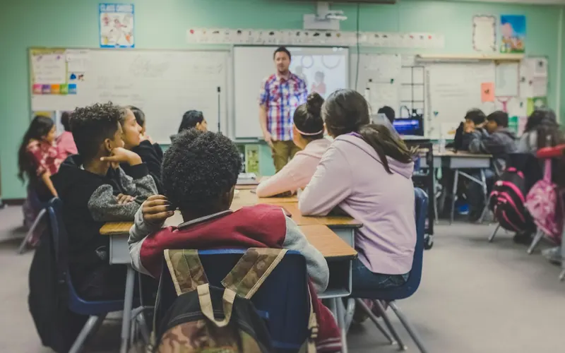 A teacher presenting to students in a classroom
