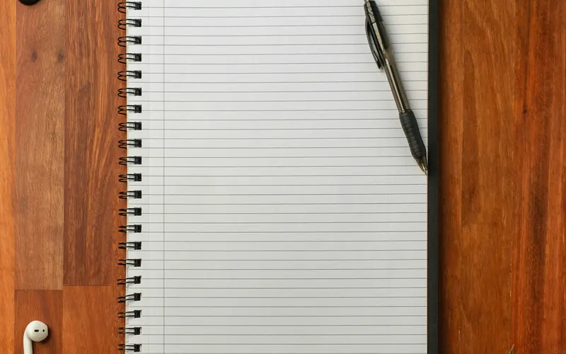 A pen resting on an open notebook