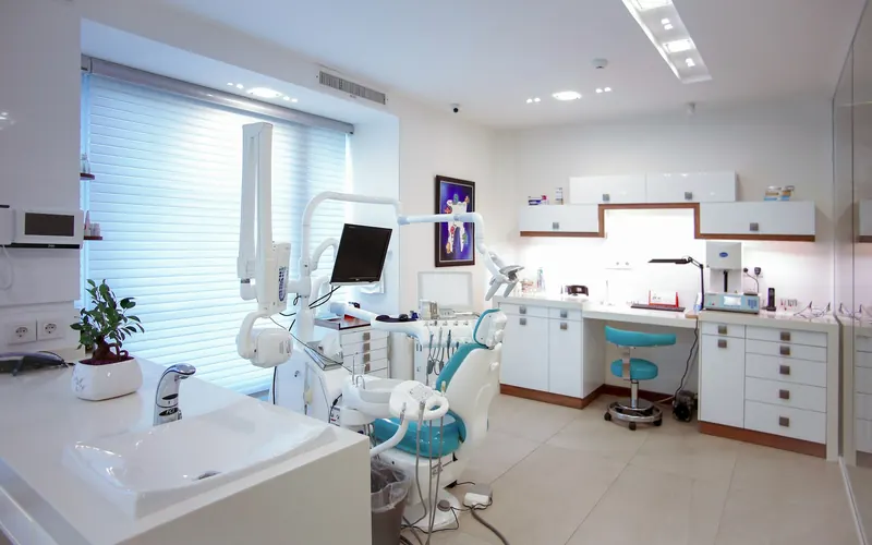 A modern dental treatment room with chair and equipment