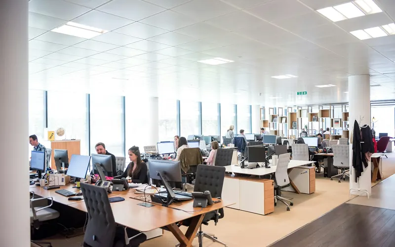 People working at desks in an open-plan office